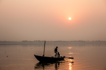 Naklejka na ściany i meble fishermen at a sunrise