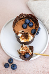 Tiramisu dessert in chocolate cup with berries
