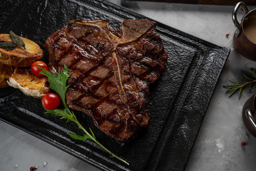 steak fried tibon with corn and wine sauce on the table.