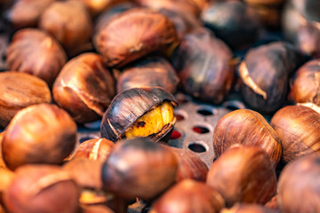 Roasted chestnuts on the plate, roasted brown chestnuts closeup 