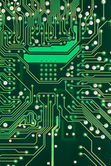 A detailed image of a small green microchip circuit board.
