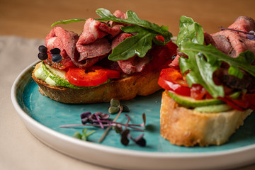 Assorted bruschetta with various toppings. Appetizing bruschetta or crudo crostini. Variety of small sandwiches. Mix bruschetta