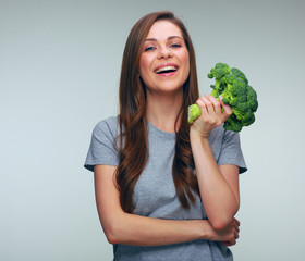 Happy woman holding perfect product for dieting green broccoli.