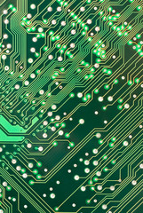 A detailed image of a small green microchip circuit board.