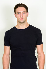 Fototapeta premium Portrait of young handsome man looking at camera