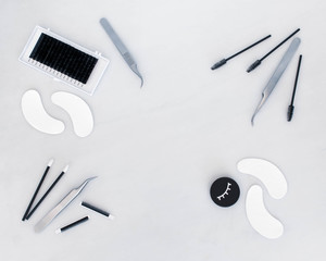 Eyelash extension treatment tools, products and equipment with space on the plain white background