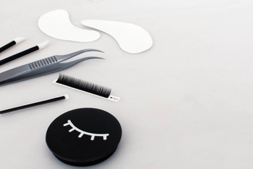 Eyelash extension treatment tools, products and equipment with space on the plain white background