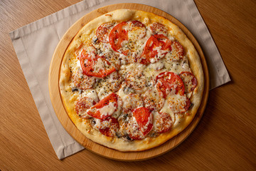 Pizza pepperoni, mozzarella, oregano on a black background