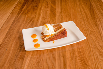 portion of carrot cake with ice cream