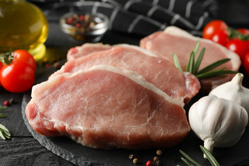 Composition with raw meat for steak and ingredients on wooden background