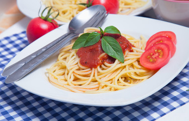Spaghetti pasta with and tomato sauce on wood background