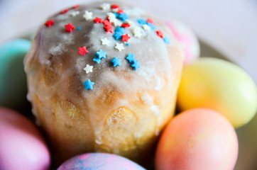 Easter Cake - Russian and Ukrainian Traditional Kulich, Paska Easter Bread and colorful eggs. Close up. Selective focus.