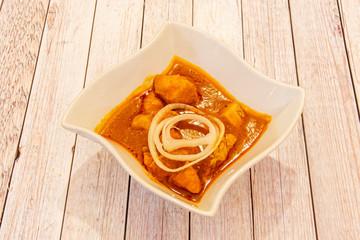 bowl of chicken curry on wooden table