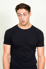 Obraz premium Portrait of young handsome man looking shocked