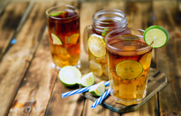 iced tea cocktail with strong drinks, wood background