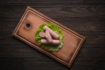 Sausages with ketchup and mustard, beer or another drink in a bottle, fast food