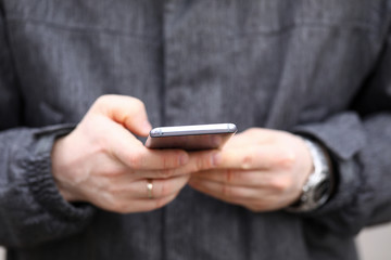 Male typing message with finger
