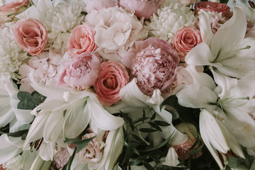 Flower arrangement out of peonies, lilies and roses