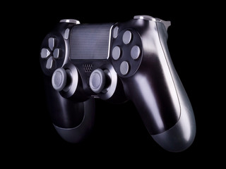Black video game joystick gamepad isolated on a black background