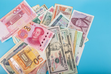 Flat lay or top view of world international banknotes vary countries background. US Dollar, Chinese...