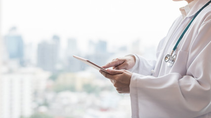 Telemedicine by medical doctor or physician consulting patient’s health telehealth online using mobile tablet in hospital for professional digital emergency tele-healthcare assistance service