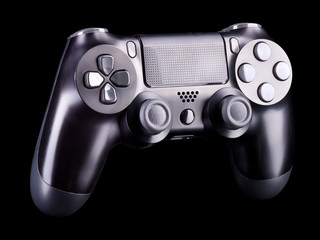 Black video game joystick gamepad isolated on a black background