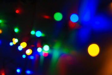 Abstract blurred colorful celebration lights shining in the darkness