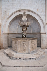 Fountain with several pipes and built in stone in Dubrovnik, Croatia, Europe.