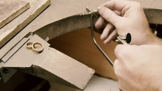 goldsmith prepares a hacksaw for gold cutting