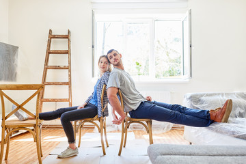 Fototapeta premium Couple takes break at renovation after relocation