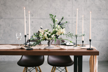 Table setting at a luxury wedding and Beautiful flowers in a vase on the table.