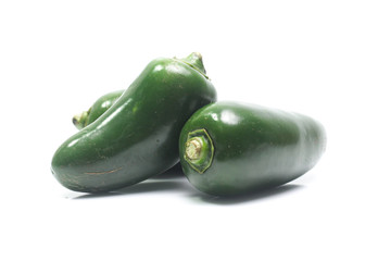 green chilies on white background (jalapeno)