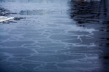 Freezing water. Lake is covered with ice. Water freezing process