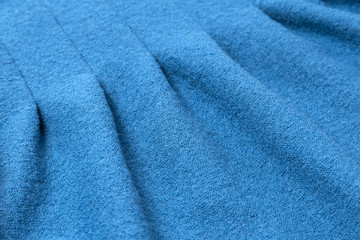 Fototapeta na wymiar blue pleated woolen coat texture