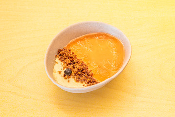 bowl of curd with cheesecake and biscuit sand