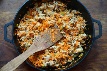 Cooking at home kitchen chicken meat side dish. Cook fry minced meat with vegetables.