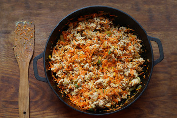 Cooking at home kitchen chicken meat side dish. Cook fry minced meat with vegetables.