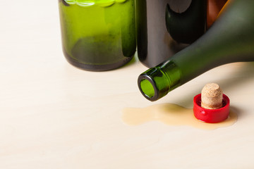 empty wine bottles and cork on wooden board