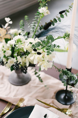 Table setting at a luxury wedding and Beautiful flowers in a vase on the table.