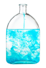 blue watercolour dissolves in water in bottle