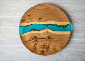 Round wooden craft tray with blue resin insert. Top view