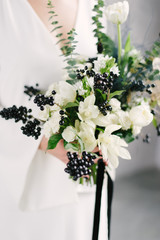 Beautiful modern wedding bouquet in the hands of the bride. black and white color scheme