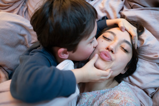 Little boy kissing his mother