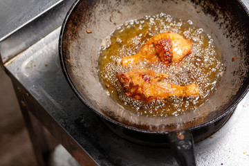 Fry the chicken in a pan with boiling oil.