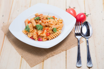 Spaghetti pasta with and tomato sauce on wood background