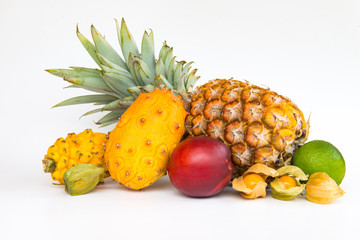 An assortment of fresh exotic fruits in basket isolated on white background.