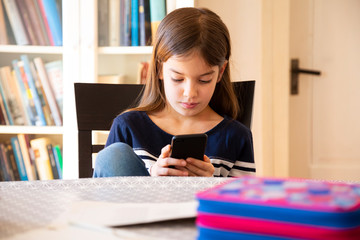 Girl doing homework with smartphone