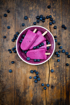 Bucket of homemade blueberry popsicles