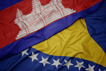 waving colorful flag of bosnia and herzegovina and national flag of cambodia.