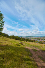 Fototapeta na wymiar View of the old part of the city of Miassa. It is located in the southern part of the city. In the background you can see the mountain ranges of the southern Urals